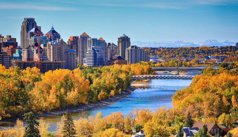 The Calgary skyline above the Bow River framed by autumn foliage